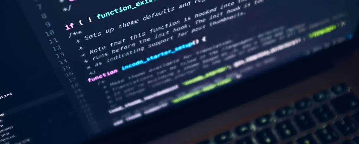A close-up of source code displayed on a laptop